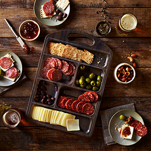 columbus charcuterie board on wood background